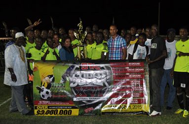 Ansa McAl Public Relations Officer Darshanie Yussuf (left) hands over the championship trophy to captain of Grove Hi Tech Sherman Doris in the presence of elated players and club officials.