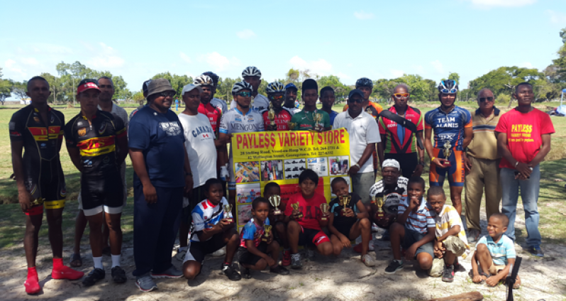 Prize winners of the various categories of yesterday’s Payless Variety Store sponsored 11-race cycle programme strikes a pose with their trophies and other prizes.