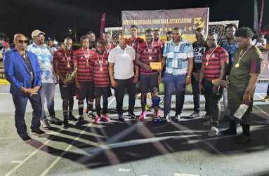 Botafago captain Donovan Francis collects $1M cash incentive from Banks DIH Linden Manager, Shawn Grant, fifth from right.