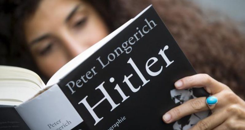A woman reads Peter Longerich's new book 'Hitler' in Berlin, Germany, November 5, 2015.
Reuters/Hannibal Hanschke