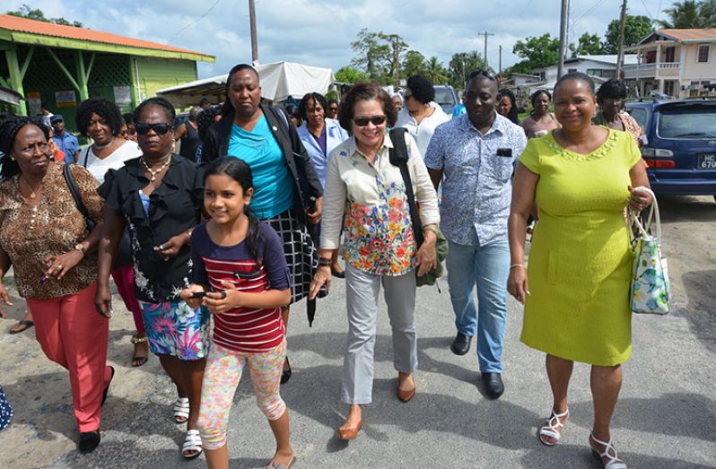 First Lady,Sandra Granger and Minister of Public Health, Ms. Volda Lawrence upon their arrival at the Supenaam Stelling, were joined by other attendees of the National Congress of Women as they make their way to the Good Hope Transformation Centre.