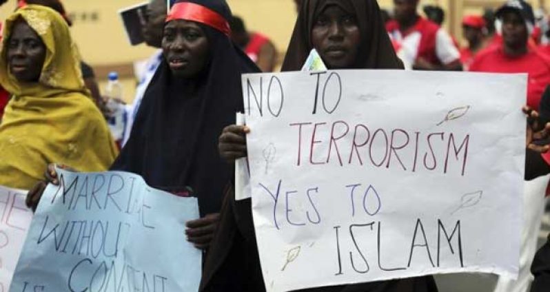 Women holding signs take part in a protest demanding the release of abducted secondary school girls from the remote village of Chibok, in Lagos May 5, 2014.REUTERS/Akintunde Akinleye