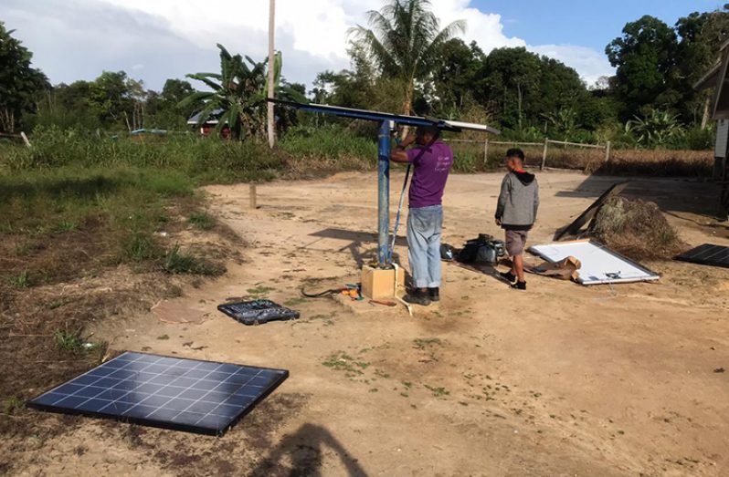 A GWI engineer installing the new solar panels