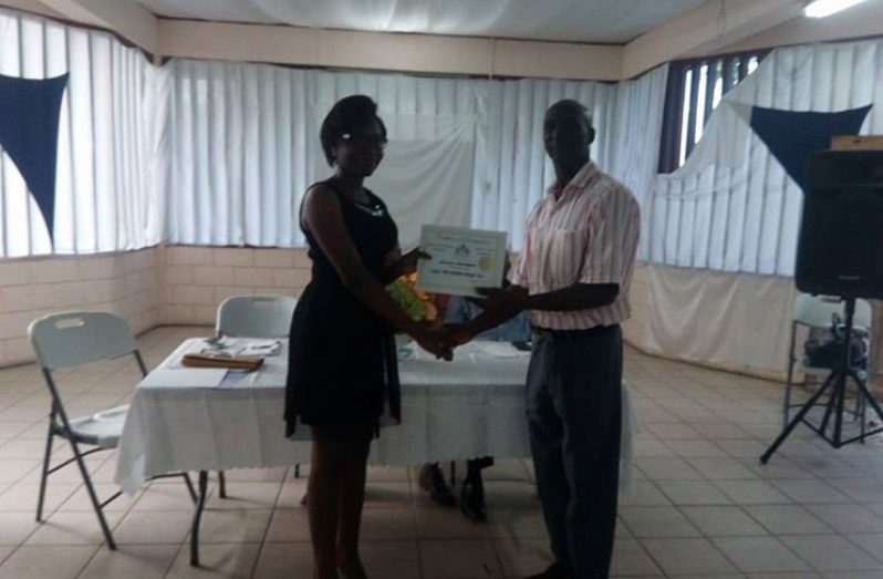 One of the participants of the programme receiving her certificate from Regional Vice Chairman Elroy Adolph