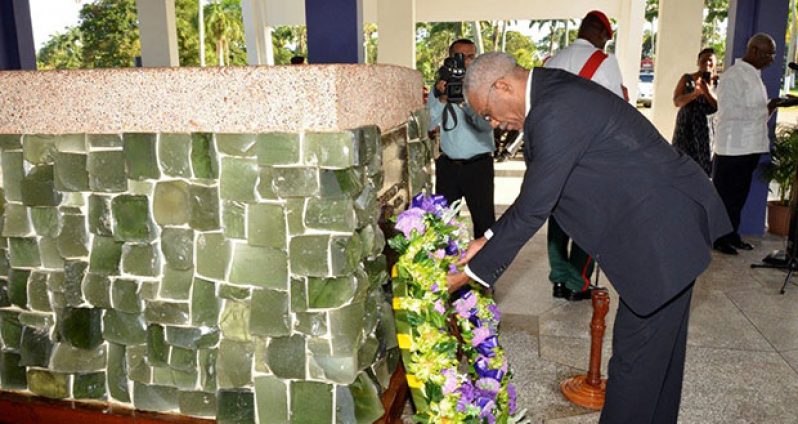 President David Granger laying a wreath at the Mausoleum in the Botanical Gardens, where the late President Burnham is buried 