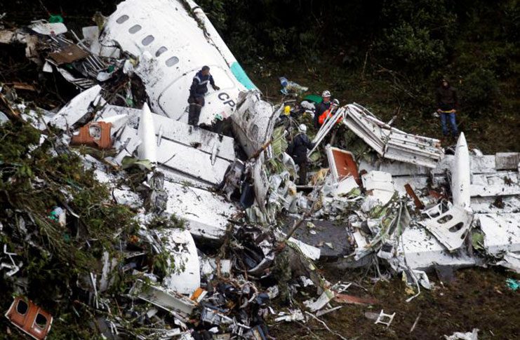 Rescue crew work in the wreckage from a plane that crashed into Colombian jungle with Brazilian soccer team Chapecoense near Medellin, Colombia, yesterday. (REUTERS/Fredy Builes)