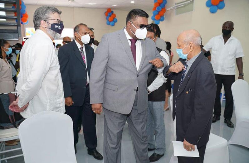 Dr. Yesu Persaud (right) greeting President Dr. Irfaan Ali