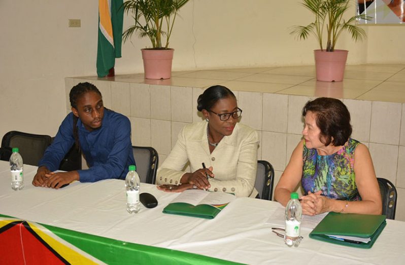 Mr. Adrian Alfred, Ministry of Education, Department of Culture, Ms. Nicolette Henry and First Lady, Mrs. Sandra Granger at the head table at the National Youth Week Symposium