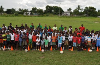 Participants and resource persons attending the EBFA/MCYS U-14 Academy take time out for a photo during the first day, yesterday, at the Grove Playfield.