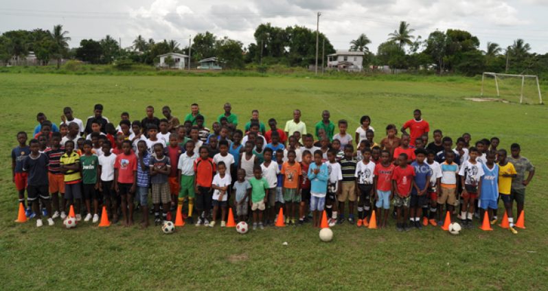 Participants and resource persons attending the EBFA/MCYS U-14 Academy take time out for a photo during the first day, yesterday, at the Grove Playfield.
